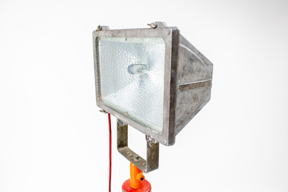 Industrial vintage emergency lamp on red tripod
